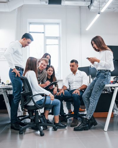 Group of young business people that standing and sitting and working in the office Group of young business people that standing and sitting and working in the office.