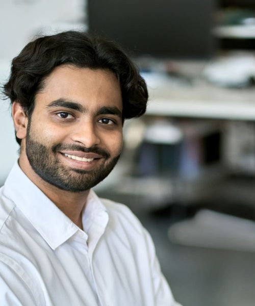 imgi_40_happy-indian-young-business-man-employee-working-o-2025-02-11-16-17-07-utc-1-e1752045618780